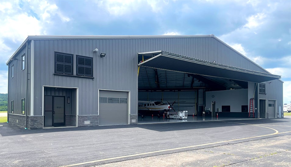 Schweiss bifold door installed on the frontside of hangar owned by Brad Mottier