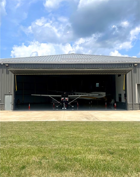 Plane parked inside of hangar fitted with Schweiss bifold door owned by Brad Mottier