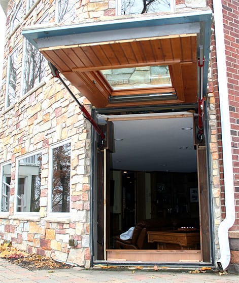 Closeup view of custom Schweiss hydraulic door fitted on the Buboltz Basement shown in the open position