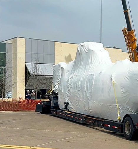 Iconic helicopter Marine One strapped to transit truck trailer, having just arrived at George H.W. Bush Presidential Library and Museum