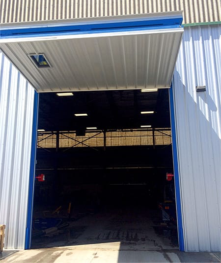 Schweiss bifold door installed on Cubex Limited building shown in open position