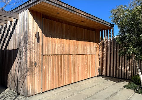 Custom Schweiss bifold door fitted on a custom bar/garage in Santa Cruz, California shown closed