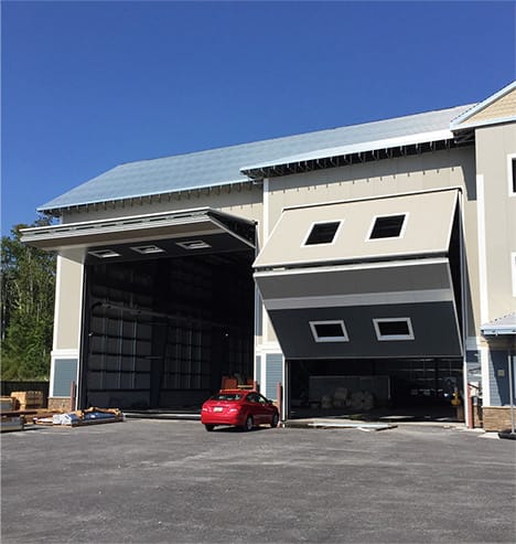 Multiple Schweiss bifold doors fitted on new building at Duffie Boatworks shown opening and opened