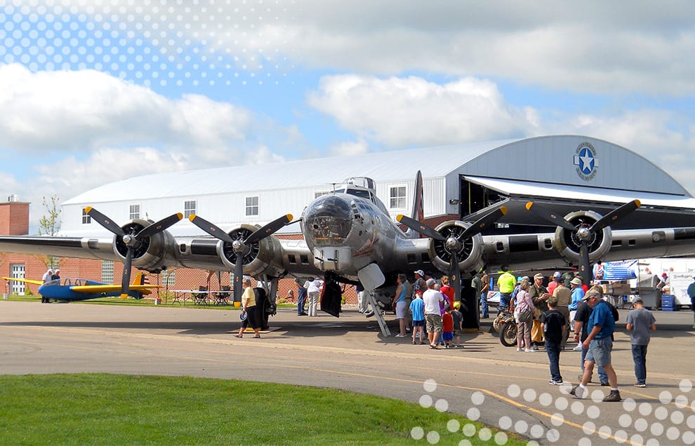 Crowd surrounding an airplane at Fagen WW2 Museum where a Schweiss bifold door was installed