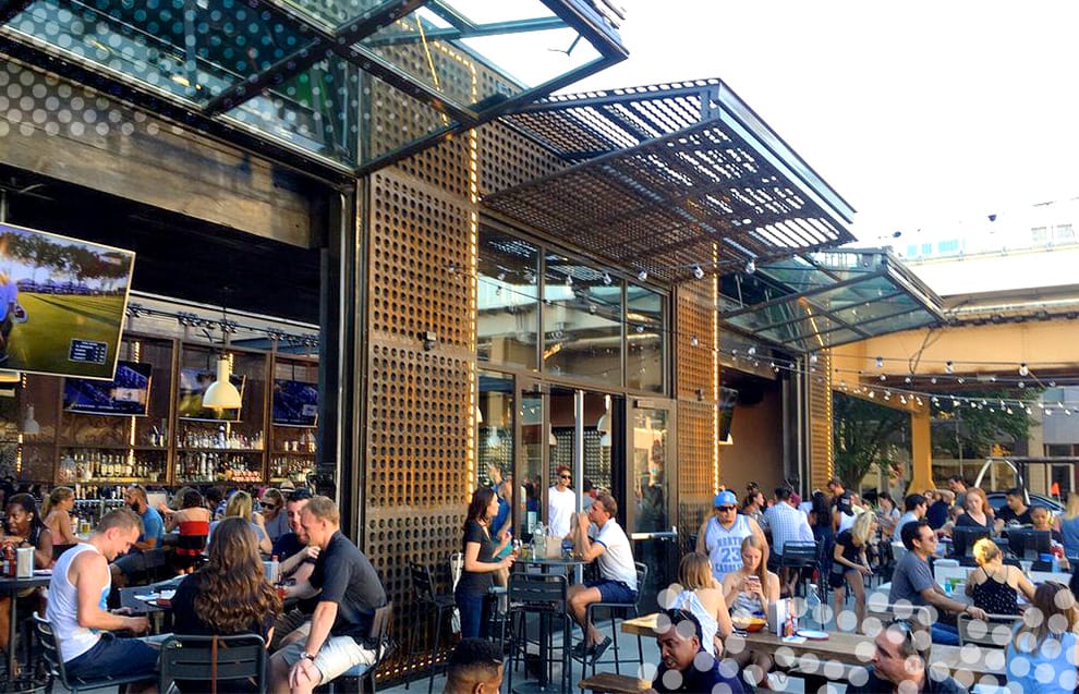 Patrons dining at Federales Tequila & Tacos underneath multiple Schweiss bifold doors in the open position