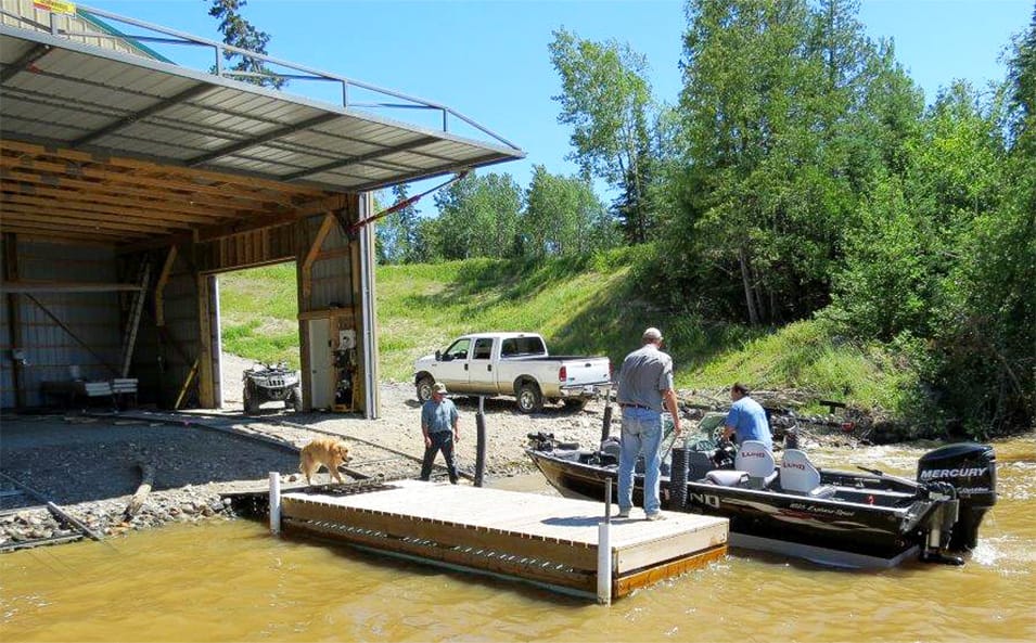 Boat docking in front of boathouse fitted with Schweiss hydraulic door