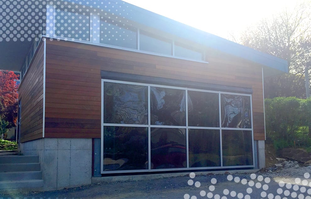 Leftside view of custom Schweiss glass hydraulic door installed on a garage in Pennsylvania