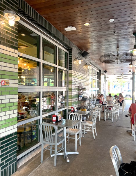 Exterior view from the left of closed Schweiss bifold glass door fitted on Goodie Goodie Burger