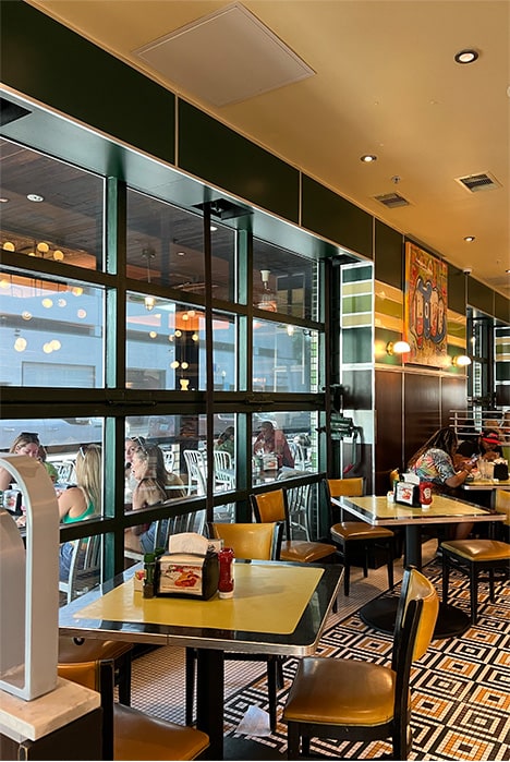 Interior view from the left of closed Schweiss bifold glass door fitted on Goodie Goodie Burger