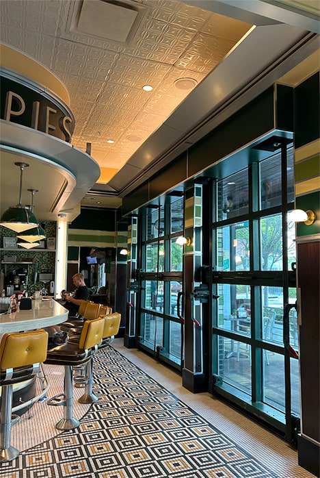 Interior view from the right of closed Schweiss bifold glass door fitted on Goodie Goodie Burger