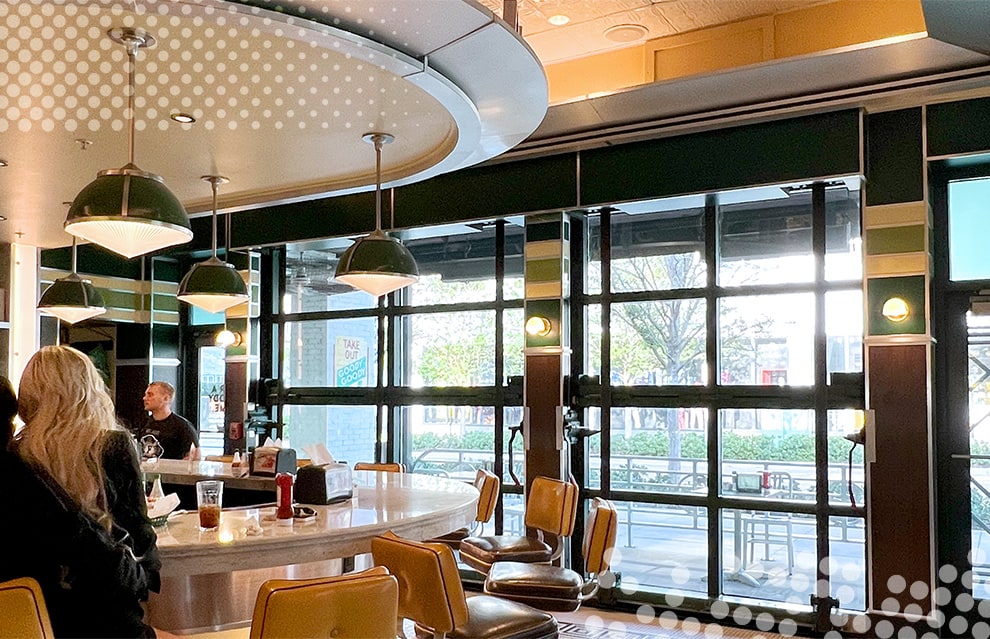 Wide interior view from the right of closed Schweiss bifold glass door fitted on Goodie Goodie Burger