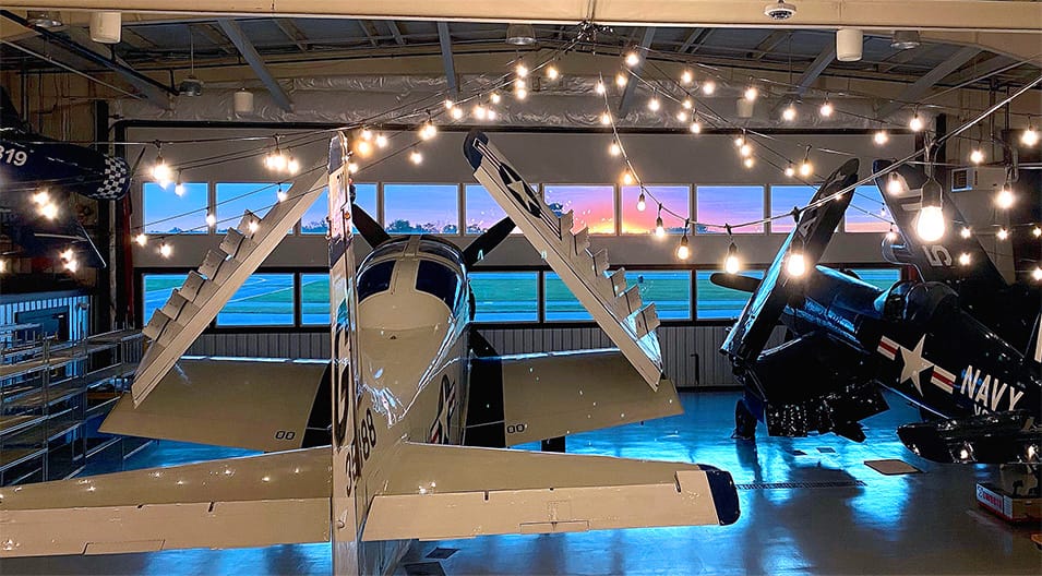 Interior view of The Hangar at 743 during the sunset, highlighting the windows of its Schweiss hydraulic door