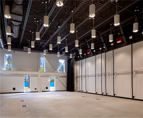 Interior view of Schweiss bifold door fitted on HOLA's Clubhouse building shown closed