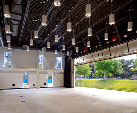 Interior view of Schweiss bifold door fitted on HOLA's Clubhouse building shown open