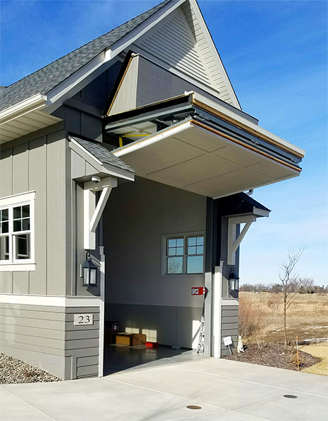 Custom Schweiss bifold door fitted on an RV garage in North Oaks, MN shown fully open