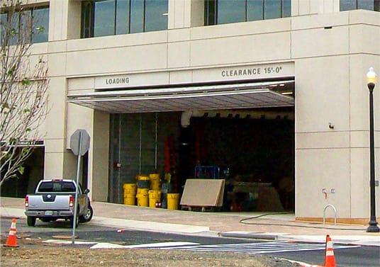 Closeup view of Schweiss bifold door installed on the parking ramp of a large hospital