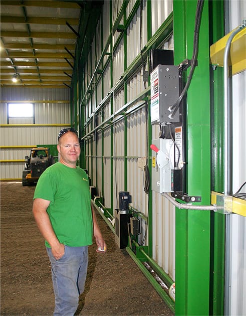 Huisman posed next to the controller for one of his Schweiss bifold doors