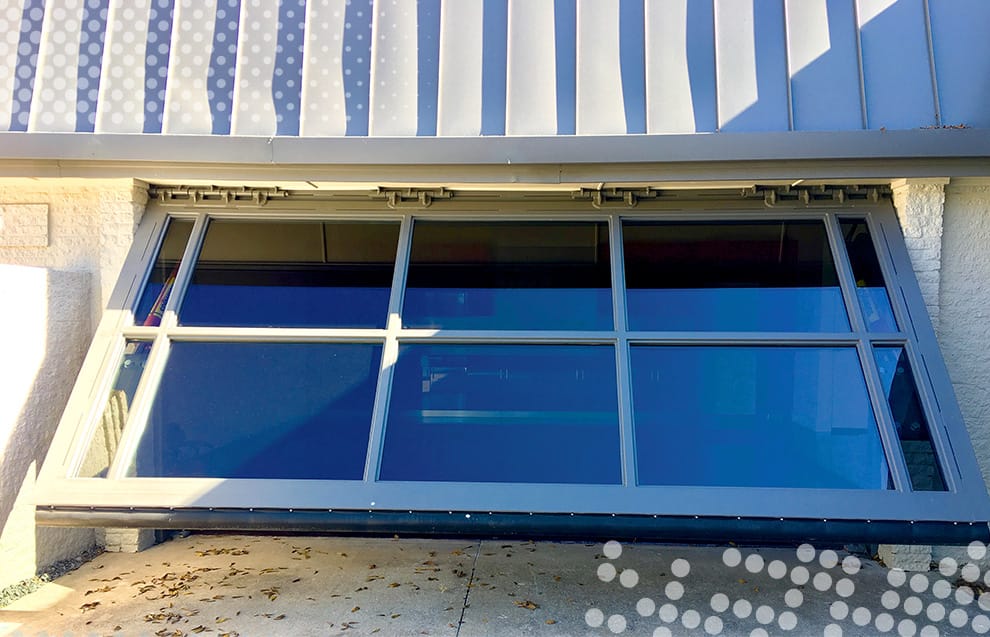 Custom Schweiss glass hydraulic door fitted on Leo Kingston's garage in Oklahoma