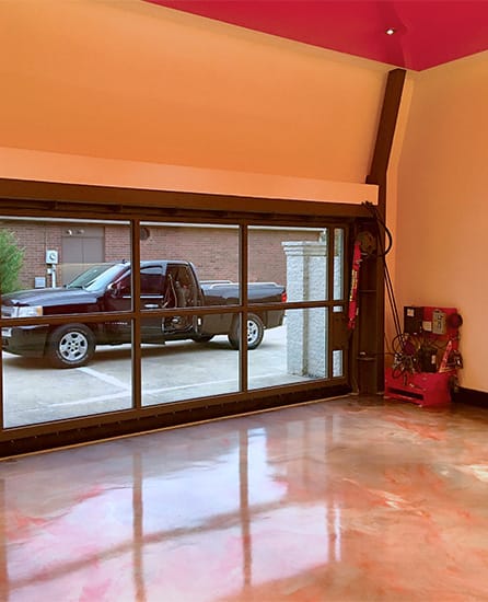 Interior view of custom Schweiss glass hydraulic door installed on Kingston's garage shown in the closed position