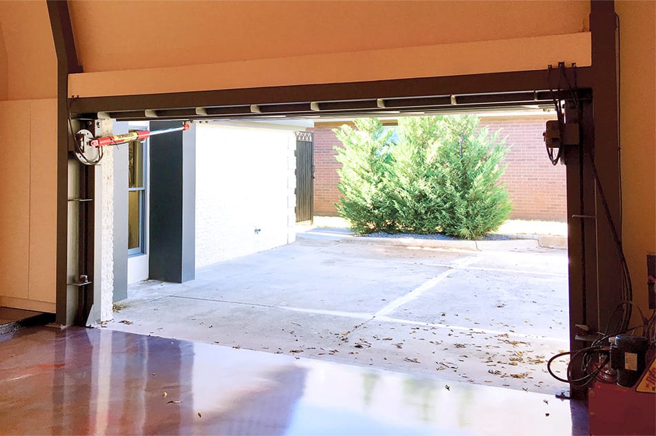 Interior view of custom Schweiss glass hydraulic door installed on Kingston's garage shown in the open position