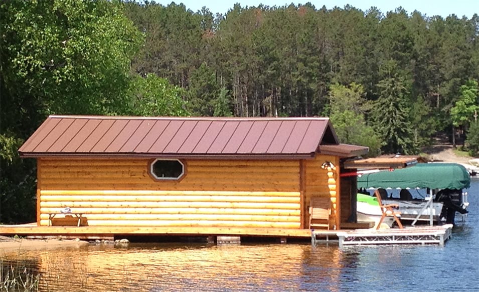 Side view of boathouse on Lake Vermilion that is fitted with a Schweiss hydraulic door shown open