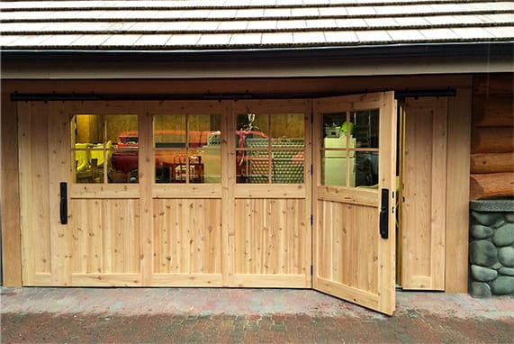 Frontal view of custom Schweiss hydraulic door fitted on a Log Cabin in Oregon shown closed