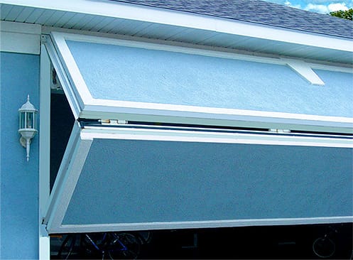 Angled view of custom Schweiss bifold door with matching cladding fitted on a garage