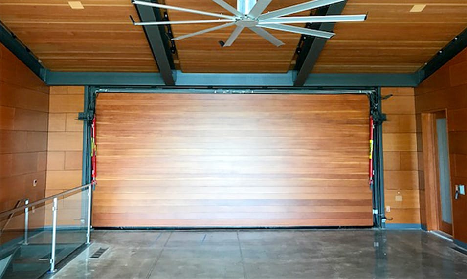 Interior view of custom Schweiss hydraulic door clad with Veritcal Douglas firm