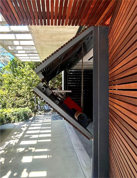 Schweiss bifold designer door fitted on contemporary home in Miami shown opening from the side