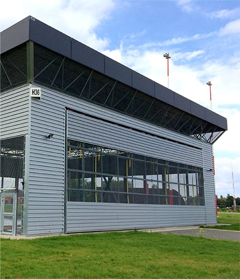 Custom Schweiss bifold door installed on Military Hangar in Belgium shown in closed position