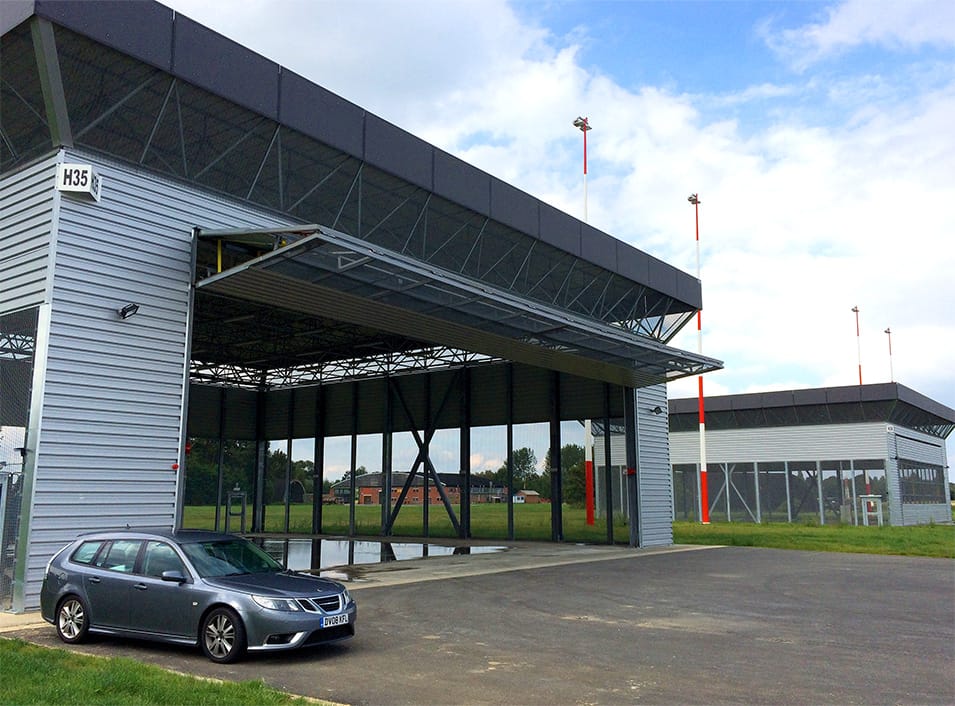 Rightside view of custom Schweiss bifold door fitted on Military Hangar in Belgium shown open