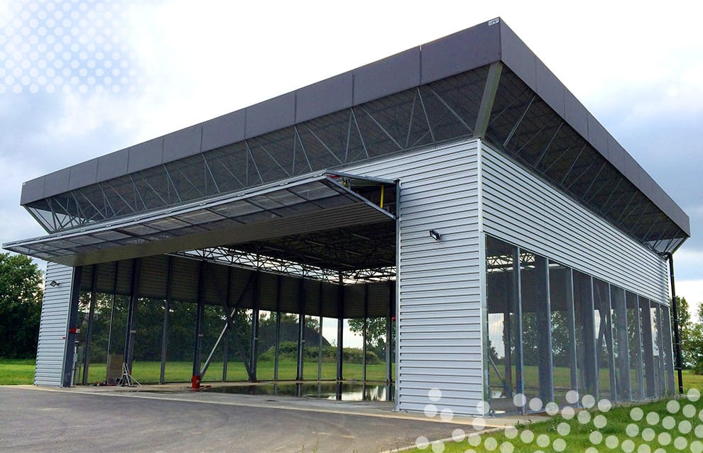 Leftside view of custom Schweiss bifold door fitted on Military Hangar in Belgium shown open
