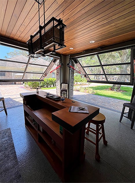 Schweiss glass hydraulic doors fitted on Mount Royal Airpark hangar shown opening from inside