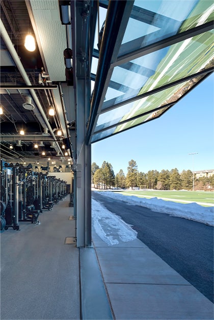 Side view of Schweiss bifold door fitted on the weight room of the NAU Student-Athlete High-Performance Center