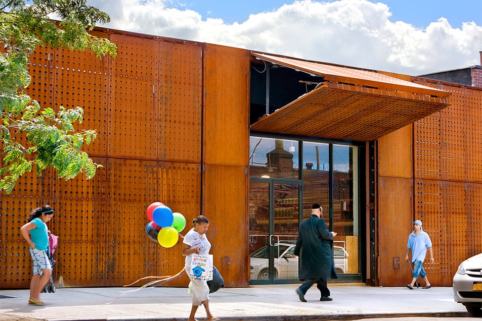 Schweiss bifold door used for security on a New York storefront shown open