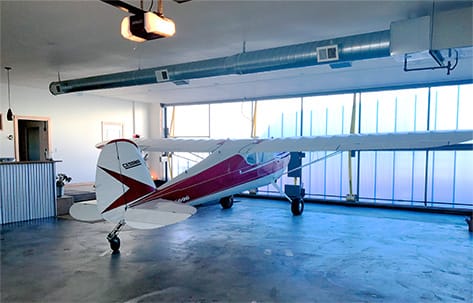 Airplane parked inside Oregon Star Hangar fitted with Schweiss bifold door