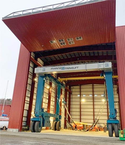 Frontal view of Portland Yacht Services building fitted with large Schweiss bifold door shown fully open