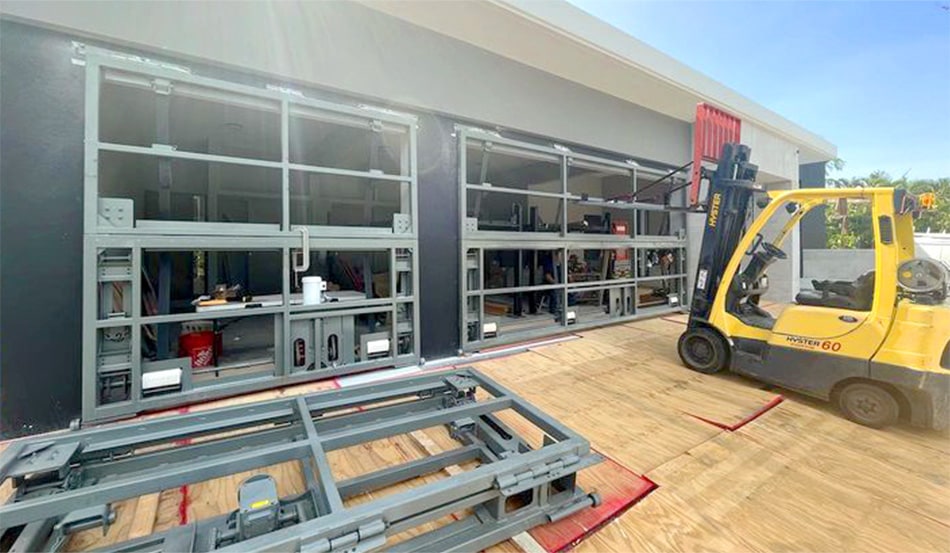 Three Schweiss bifold frames, two already installed, during installation on Puerto Rico residence