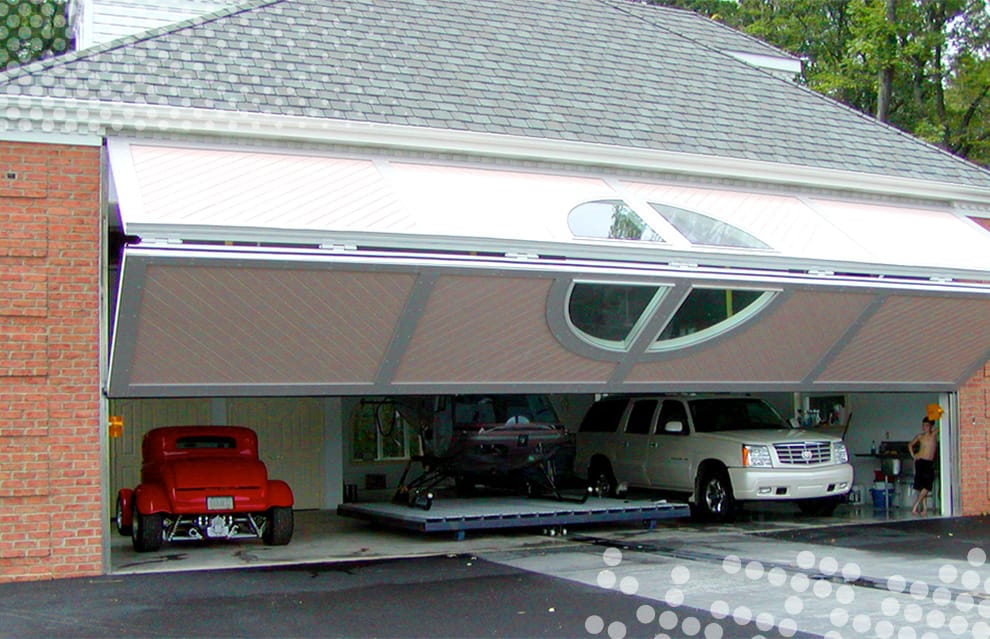 Custom Schweiss bifold door with a round window fitted on a garage in Pennsylvania