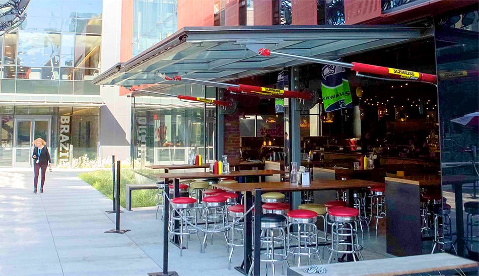 Angled view showing Schweiss hydraulic doors fitted on Sams Tavern over the patio