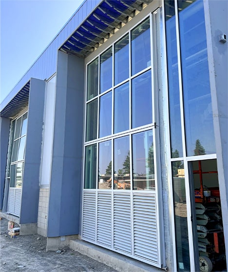 Closed Schweiss glass bifold door installed on San Bernardino Valley College's tech building viewed from the right