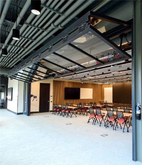 Schweiss bifold door cladded with glass installed on Colorado School of Mines Beck Venture Center shown open