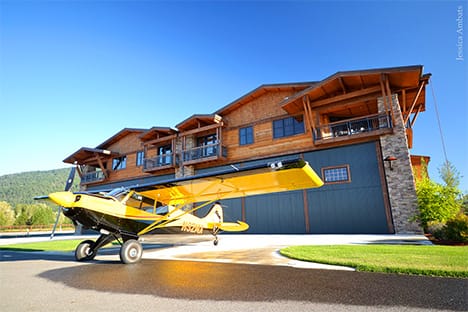 Airplane parked outside hangar fitted with a Schweiss bifold door at Silverwing Airpark