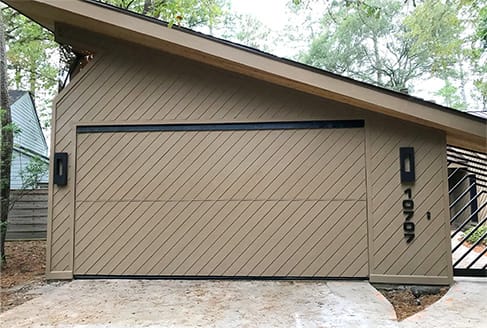 Custom Schweiss bifold door fitted on Simonds' garage shown in the closed position