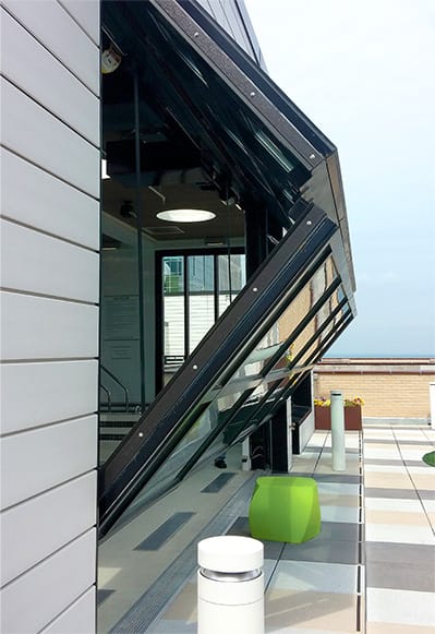 Side view of Schweiss bifold door installed on Soo Line Apartments shown half open