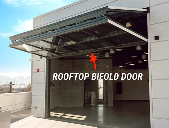 Closeup view of Schweiss bifold door installed on the rooftop of Spy Hop