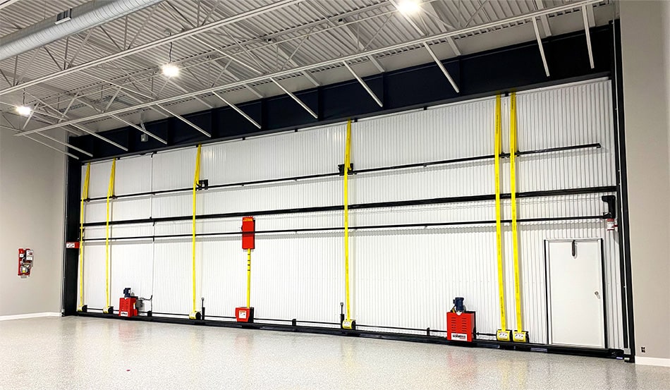 Interior view of Schweiss bifold door fitted on hangar home in Stellar Airpark, showing the lift strap system