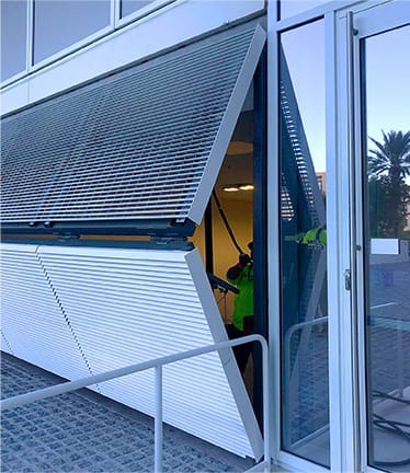 Schweiss bifold security door installed on The Surf Club shown half open