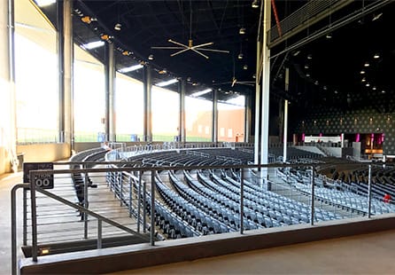 Interior view of the Toyota Music Factory showing seating, the stage, and multiple Schweiss bifold doors in the open position