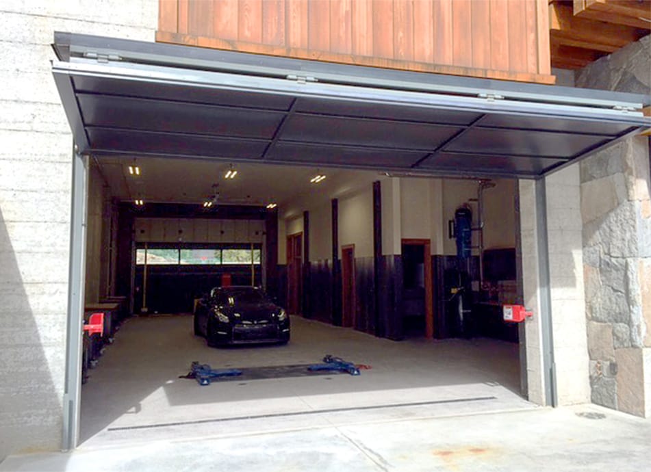 Custom Schweiss bifold door fitted on garage in Truckee, CA shown open